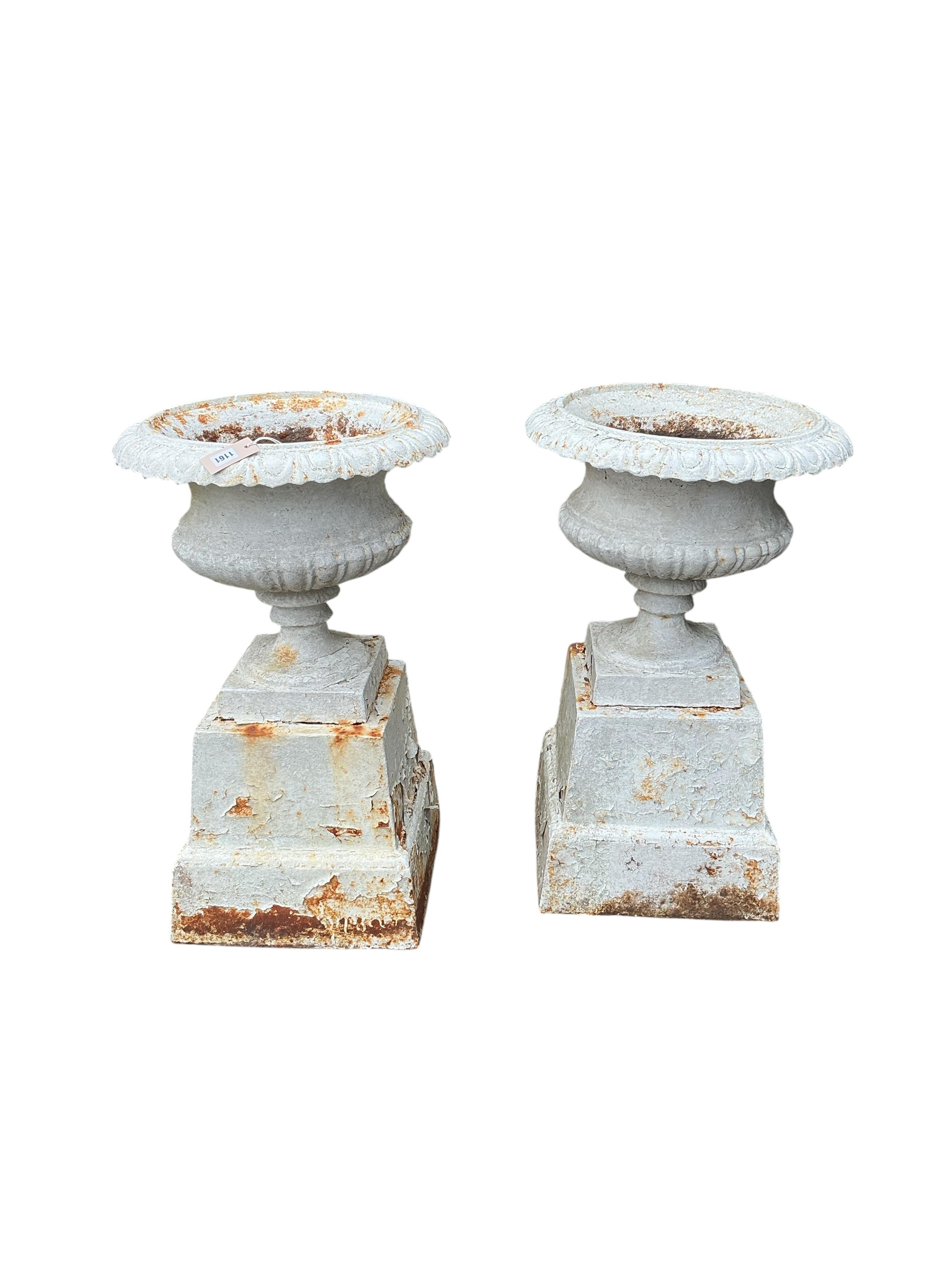 A pair of Victorian painted cast iron campana urns on square bases, diameter 48cm, height 80cm